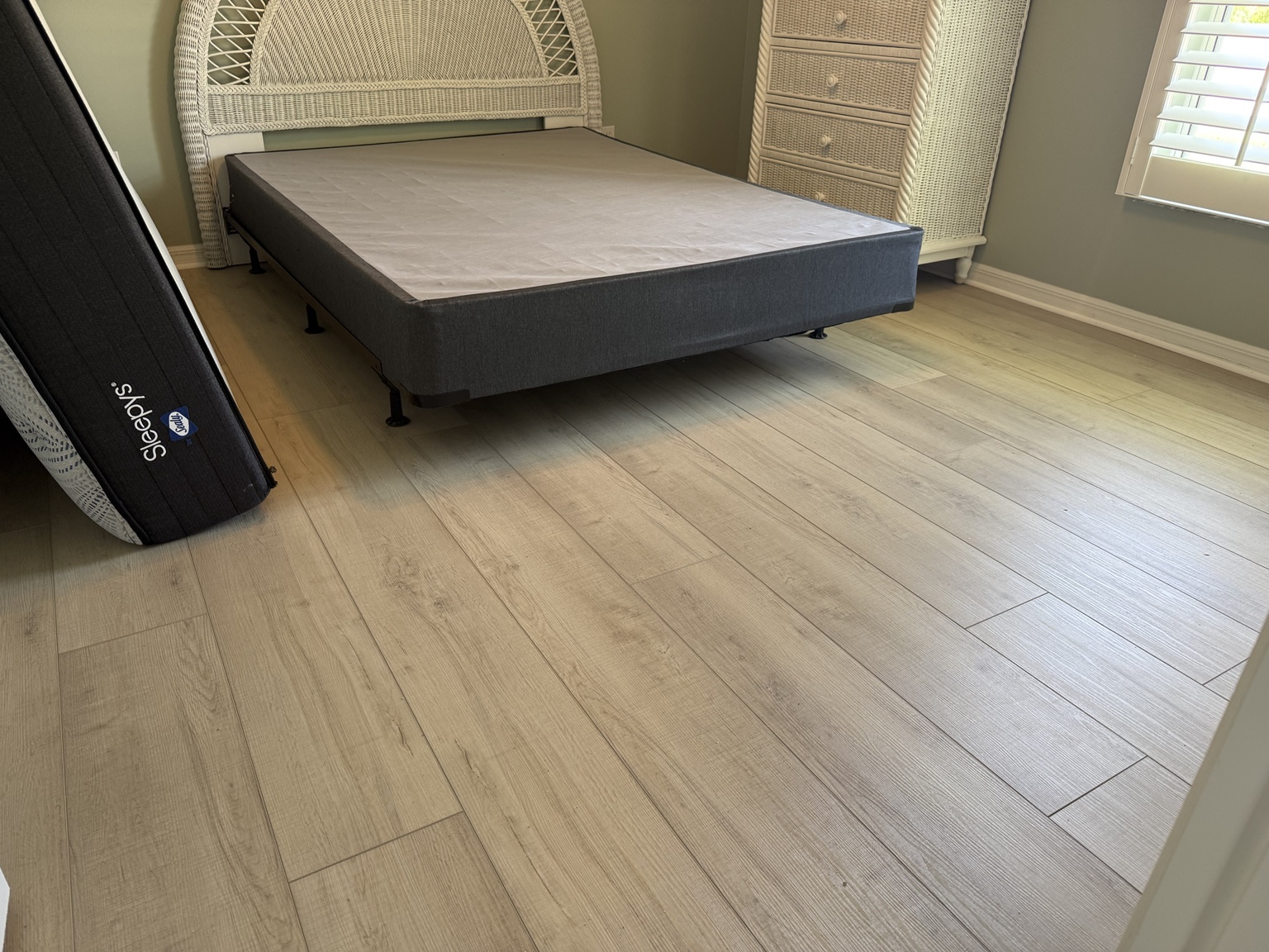 Light wood-look luxury vinyl plank flooring installed in a bedroom